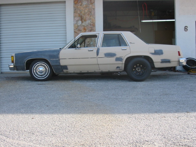 Side view of a 1985 Ford Crown Victoria LTD undergoing bodywork