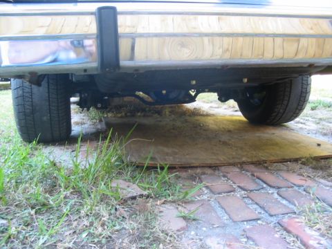 1985 Ford LTD Crown Victoria - The rear axle and suspension components are visible beneath the chrome bumper.
