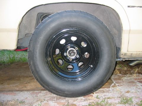 1985 Ford LTD Crown Victoria - A close-up view of a black aftermarket wheel and tire mounted on a vehicle.
