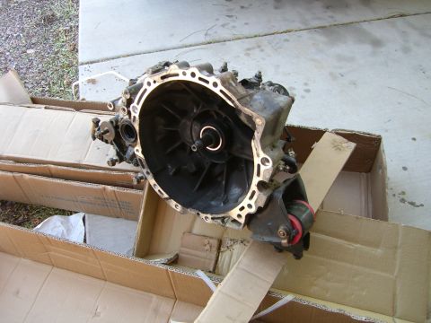 1996 Ford Probe - A transmission part is shown resting in cardboard boxes outdoors.
