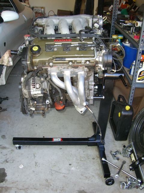 1996 Ford Probe - Mazda V6 engine removed from a vehicle and mounted on an engine stand for repair or rebuilding.