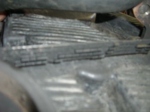 1996 Ford Probe - Close-up view of a vehicle's engine belt and associated pulleys.