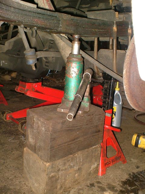 1989 Ford Bronco - Vehicle suspension work in progress, using jacks and stands for support.