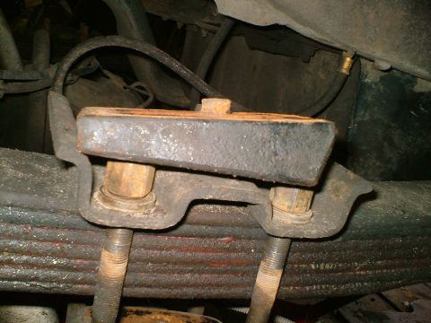 1989 Ford Bronco - This photo shows a close-up of a vehicle's rear leaf spring shackle, likely during a modification or repair.