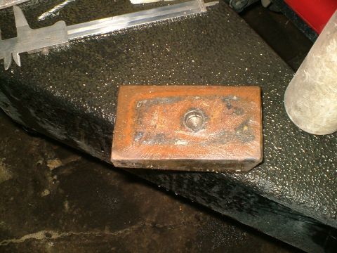 1989 Ford Bronco - A shim is shown with a caliper tool, likely for measurement during installation.