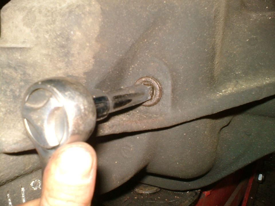 Differential housing with a socket wrench turning a bolt