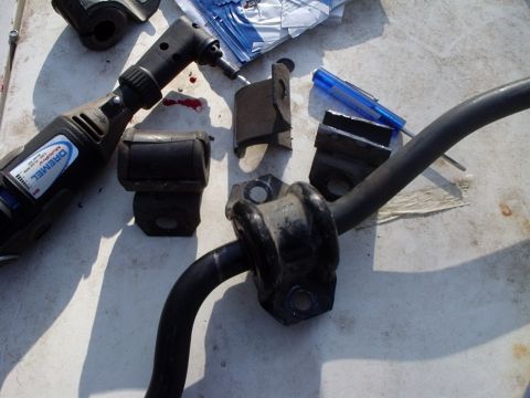 2000 Ford Taurus - Car parts and a Dremel tool are laid out on a surface, possibly for repair or modification.