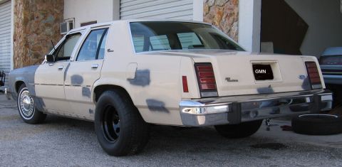 1985 Ford LTD Crown Victoria - This Ford sedan appears to be in the process of being repaired or repainted, with visible primer spots on its body panels.