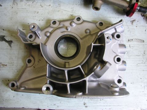 1996 Ford Probe - Engine oil pump housing with visible casting marks and a seal.
