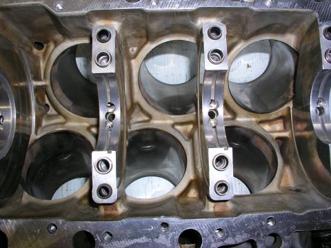 1996 Ford Probe - Close-up view of an engine block's bearing saddles and caps, likely during a rebuild or inspection.