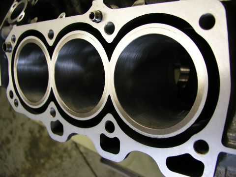 1996 Ford Probe - Close-up view of an engine block's cylinders, revealing the honed interior surfaces.