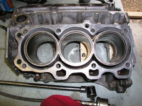 1996 Ford Probe - Close-up view of an engine block, showing three cylinders and parts of the pistons within.