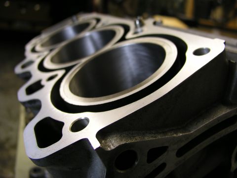 1996 Ford Probe - The machined surface of an engine's cylinder block shows three precisely bored cylinders.