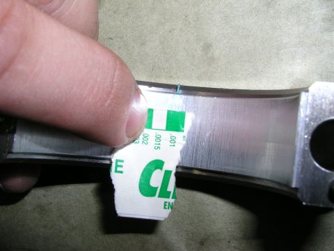 1996 Ford Probe - Plastic gauge is used to measure bearing clearance on an engine part during a turbo motor rebuild.