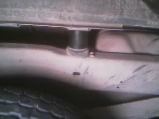 1986 Ford Bronco - Close-up of the undercarriage, showing a suspension part and tire.