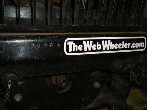 1990 Ford Bronco - A close-up view of a sticker on a black surface, with some unreadable markings nearby.
