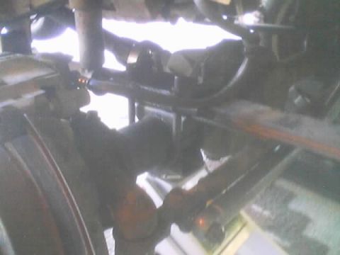 1990 Ford Bronco - close underbody shot showing leaf springs, axle housing and steering linkage of a lifted vehicle.