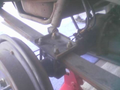 1990 Ford Bronco - Underbody detail of a fabricated spring perch with U-bolts mounting a leaf spring to the frame.
