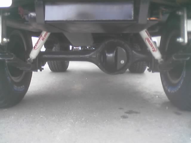 Rear underside view of a vehicle's axle and Rancho shocks
