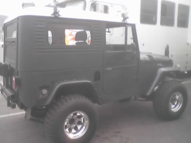 Side view of gray hardtop 4x4 with flame reflection in window