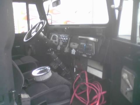 1990 Ford Bronco - Interior of a vintage 4x4 showing the dash, steering wheel, a chrome air cleaner on the seat and red wiring.