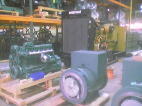 1968 Ford Mustang - Various engine and generator components are stored on pallets within a warehouse setting.