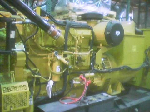 1968 Ford Mustang - Close-up view of a large yellow generator engine, showing various hoses, wires, and components.