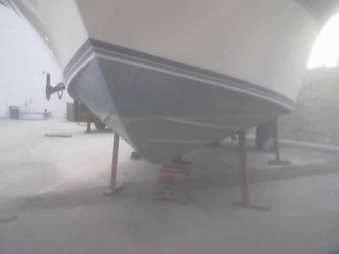1968 Ford Mustang - The underside of a boat is supported by stands, revealing its hull structure.