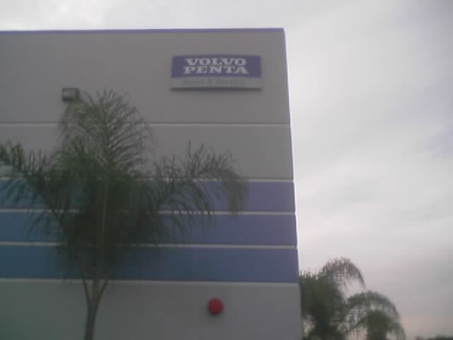 Building exterior with Volvo Penta sign and palm tree