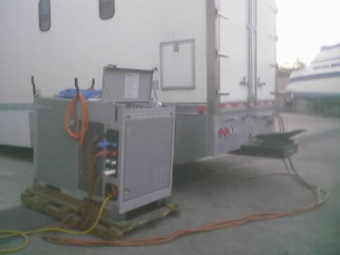 1968 Ford Mustang - Generator unit and trailer parked outdoors with cables running across the ground.