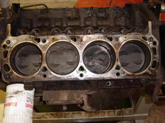 Driver's side, gasket stuck to head instead.  Notice the huge baked-on carbon deposits up in the lifter valley in this shot and the last -- up to 1" thick in places.  I won't be able to get the #6 exhaust lifter out without chiseling off carbon above it.
