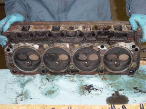 1991 Ford Bronco - Driver's side head, w/ gasket. Check out all the beautiful carbon buildup in the combustion chambers.
