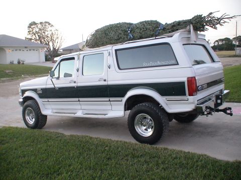 1993 Ford C-350 (Centurion Conversions) - This four-door Ford Bronco is hauling a Christmas tree on its roof.