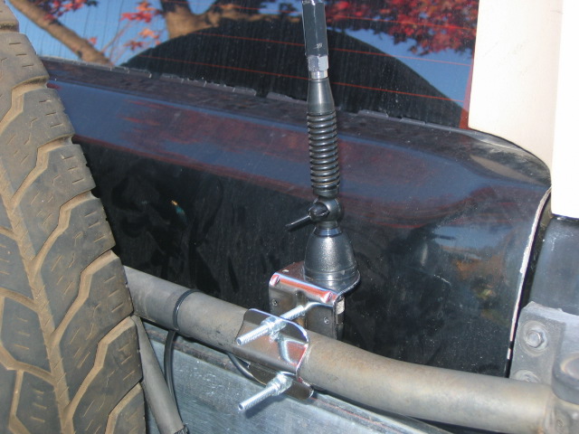 Here is a closeup of the mount. Both are made by firestick. Its a spring and tilt base, so if i need to go in a parking garage or what not, it folds down. You can also see how i ran the wire along the spare tire mount. This way makes it so only a couple extra inches are needed when the spare tire is swung out.