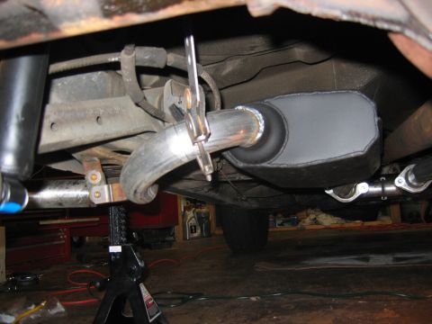 1985 Ford LTD Crown Victoria - Underneath view of a car's exhaust system, showing a muffler and pipe.