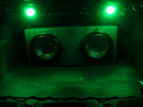 2000 Ford Taurus - Custom dual subwoofer box with green LED lighting installed in a vehicle's trunk.