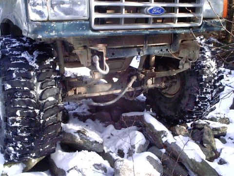 1989 Ford F-350 - Front view of a 1989 Ford F-350 navigating rough, snowy terrain with large tires.