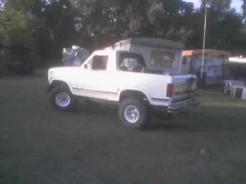1986 Ford Bronco - This white SUV has a lifted suspension and off-road tires, suggesting it is not a 1986 model.
