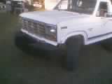 1986 Ford Bronco - Front view of a lifted 1986 Ford Bronco with large tires.