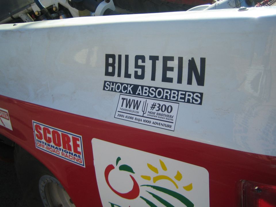 Close-up of Bilstein Shock Absorbers decal on a red and white race truck