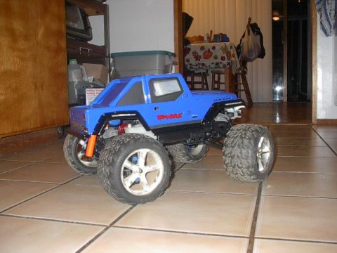 1993 Ford Bronco - This blue remote control monster truck features prominent Traxxas and Rubicon branding on its body.