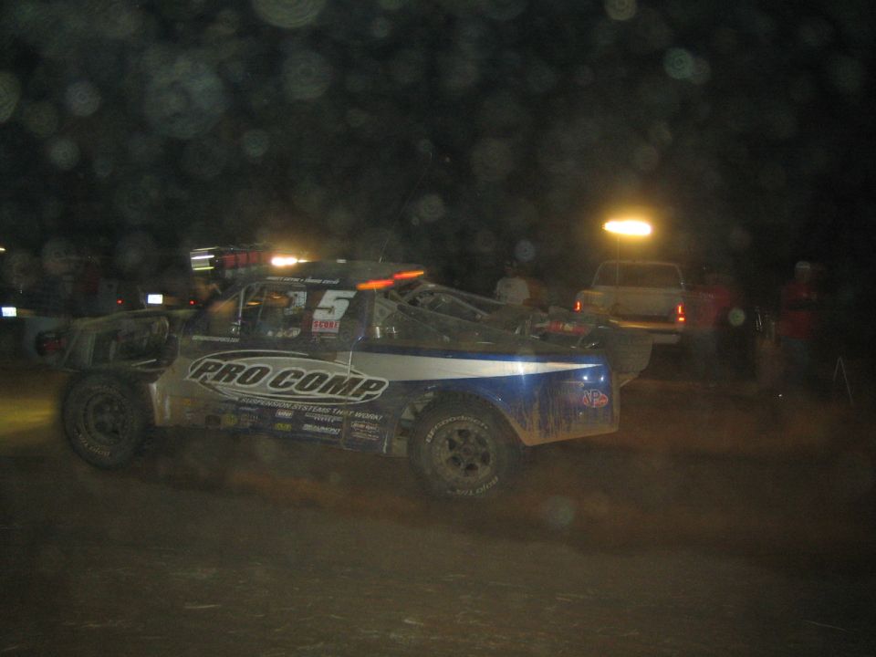 Pro Comp sponsored off-road race truck number 5 at a night event
