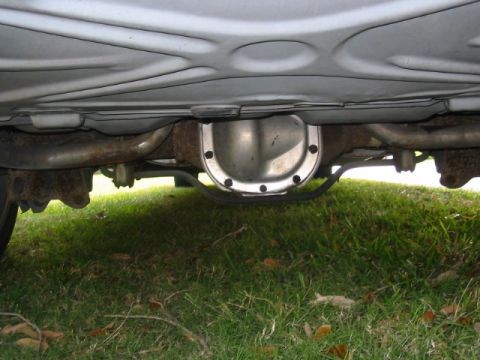 1997 Ford Crown Victoria - Underside view shows the rear differential and exhaust pipes of a vehicle.
