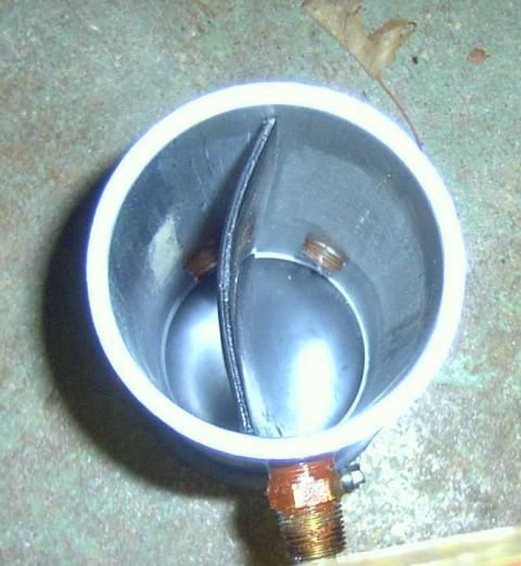 1997 Ford Taurus - This is a close-up view of a PCV catch can, showing its internal baffle and threaded connections.