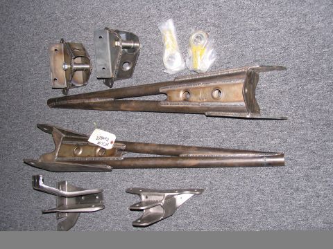 1984 Ford Bronco - Various metal vehicle suspension parts are displayed on a textured gray background.