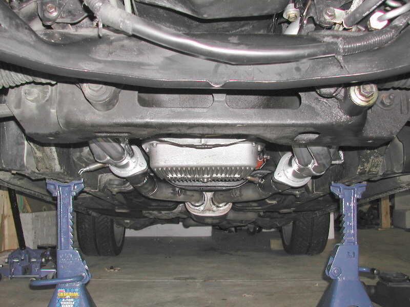 Underside view of vehicle exhaust and transmission on jack stands