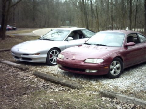1995 Ford Probe - Two coupes parked side-by-side in an outdoor lot with a "SUPERMOTORS" watermark.