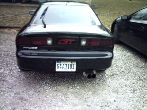 1995 Ford Probe - Rear view of a black 1995 Ford Probe GT parked next to another black vehicle.