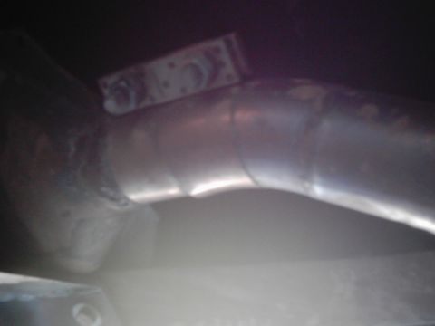 1978 Ford Bronco - Detail of an exhaust pipe section, likely from a vehicle's undercarriage.