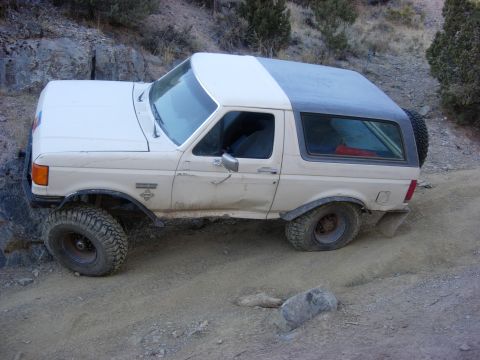 1987 Ford Bronco - This 1987 Ford Bronco is shown in a side profile on a rough, dirt terrain.